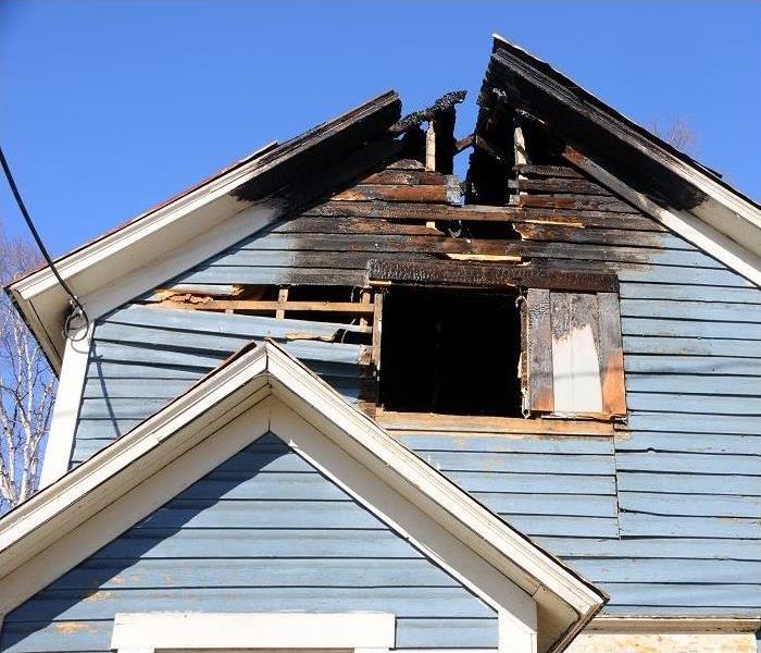 Fire damaged blue sided home