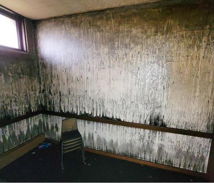 Fire damaged room; heavy soot on walls